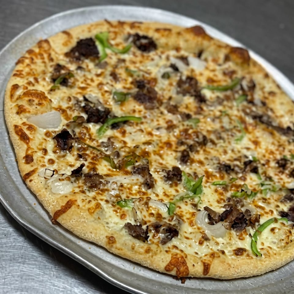 Cheesy pizza topped with mushrooms, onions, and green peppers on a metal tray.